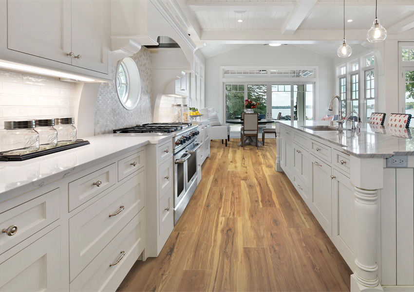 wood look laminate flooring in kitchen with white cabinets and counters